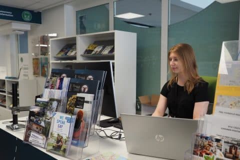 Person on computer at Tourist Office